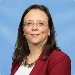 Ellen Falbo smiling in a navy blazer